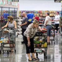 Shoppers browse the frozen food cases