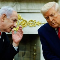 Israeli Prime Minister Benjamin talks to President Donald Trump during a meeting in the Oval Office on April 7, 2025.