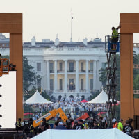 Production crews work on the stage ahead the U.S. Army's 250th Anniversary Parade on the National Mall on June 12, 2025 in Washington.