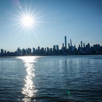 The sun rises over the New York skyline as seen from Weehawken N.J., on June 20, 2025.