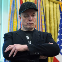 Elon Musk listens as President Donald Trump speaks during a news conference in the Oval Office of the White House.
