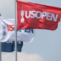 Jun 10, 2025; Oakmont, Pennsylvania, USA; Flags fly over the grandstand at the eighth hole during a practice round for the U.S. Open golf tournament at Oakmont Country Club. Mandatory Credit: Charles LeClaire-Imagn Images