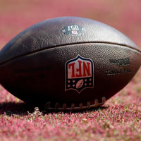 LANDOVER, MD - SEPTEMBER 15: A close up view of a Wilson official NFL "The Duke" brown leather football with NFL shield logo on painted red / burgundy natural grass in the end zone during the New York Giants versus Washington Commanders National Football League game at Northwest Stadium on September 15, 2024 in Landover, MD. (Photo by Randy Litzinger/Icon Sportswire via Getty Images)