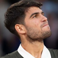 Jun 8, 2025; Paris, FR; Carlos Alcaraz of Spain poses with the trophy after winning the men’s singles final against Jannik Sinner of Italy on day 15 at Roland Garros Stadium. Mandatory Credit: Susan Mullane-Imagn Images