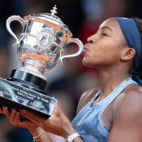 Jun 7, 2025; Paris, FR;  Coco Gauff of the United States kisses the trophy after winning the womens singles final against Aryna Sabalenka on day 14 at Roland Garros Stadium. Mandatory Credit: Susan Mullane-Imagn Images