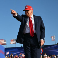 Donald Trump  pointing on stage