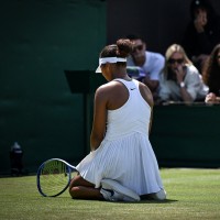 Japan's Naomi Osaka sitting onthe ground