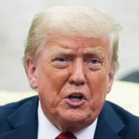 Donald Trump speaks while seated in the Oval Office
