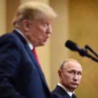 Donald Trump speaks as Vladimir Putin listens
