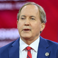 Ken Paxton gestures while speaking.
