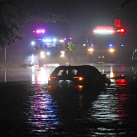 A car sits in floodwaters in Plainfield, N.J.