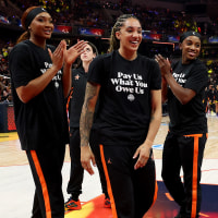  Kiki Iriafen #44 of the Washington Mystics, Gabby Williams #5 of the Seattle Storm, Jackie Young #0 of the Las Vegas Aces, Sonia Citron #2 of the Washington Mystics and Brittney Sykes #15 of the Washington Mystics wear shirts saying "Pay us what you owe us" prior to the WNBA All-Star Game on July 19, 2025 in Indianapolis, . 