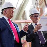 President Donald Trump points to a cost sheet as he speaks with Federal Reserve chair Jerome Powell at the Federal Reserve in Washington on July 24, 2025. 