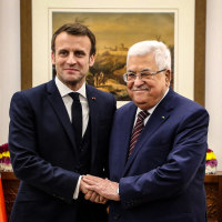 Image: French President Emmanuel Macron shakes hands with Palestinian President Mahmoud Abbas