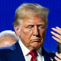 President Donald Trump prays with Pastor Paula White and other faith leaders