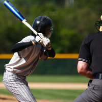 View of baseball batter from behind the catcher as they hit