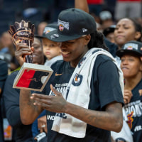 Jul 1, 2025; Minneapolis, Minnesota, USA; Indiana Fever forward Natasha Howard (6) hols up the Most valuable Player trophy after defeating the Minnesota Lynx during the Commissioner's Cup final at Target Center. Mandatory Credit: Jesse Johnson-Imagn Images