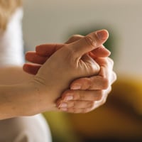 Close up shot of woman cracking her knuckles.
