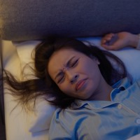 asian woman poor sleep quality