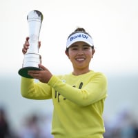Miyu Yamashita holds up her trophy and smiles outside