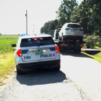 Vehicles are seen being taken by the Tennessee Bureau of Investigation