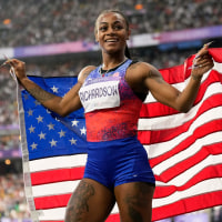 Sha'carri Richardson holds the U.S. flag.