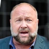 A split composite images of two stacked flags waved in the air, left, and Alex Jones