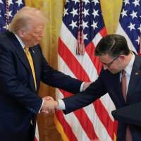 President Donald Trump and House Speaker Mike Johnson shake hands at a reception at the White House 