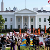 Activists protest President Donald Trump's federal takeover of policing of the District of Columbia near the White House on Saturday, Aug. 16, 2025.
