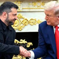 Volodymyr Zelenskyy, left, and Donald Trump shake hands
