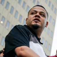 Kilmar Abrego Garcia speaks at a podium
