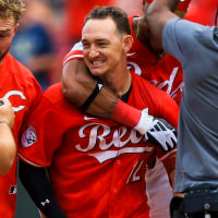 Aug 17, 2025; Cincinnati, Ohio, USA; Cincinnati Reds designated hitter Austin Hays (12) celebrates with teammates after hitting a walk-off single in the tenth inning against the Milwaukee Brewers at Great American Ball Park. Mandatory Credit: Katie Stratman-Imagn Images