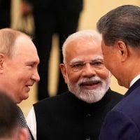 Indian Prime Minister Narendra Modi, center, talks with Russian President Vladimir Putin, left, and Chinese President Xi jinping