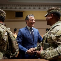 Defense Secretary Pete Hegseth greets a member of the National Guard at Union Station in Washington on Aug. 20, 2025. 