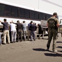 Manufacturing plant employees waiting to have their legs shackled at the Hyundai Motor Group’s electric vehicle plant on Sept. 4, 2025, in Ellabell, Ga.