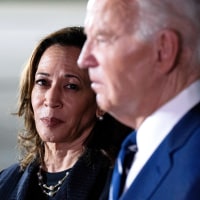 Kamala Harris, left, looks at Joe Biden as they stand next to each other