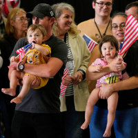 Afrikaner refugees holding US flags.
