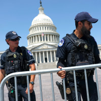 Police officers work near the Capitol on June 23, 2025.