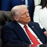 President Donald Trump listens as Sen. Katie Britt, R-Ala., speaks in the Oval Office of the White House.