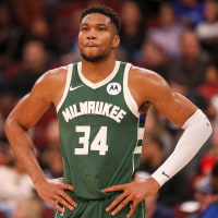 Giannis Antetokounmpo stands on the basketball court
