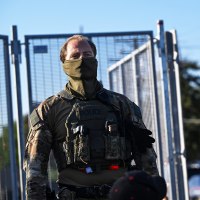Federal Agents stand outside the Immigration and Customs Enforcement facility.