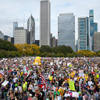 Demonstrators protest during the "No Kings" march in Chicago, IL.