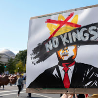 A protester holds a "No Kings" sign at a rally during a national day of protest.