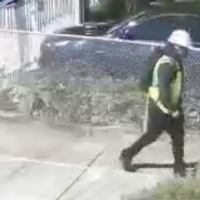 Surveillance video of robbery suspects in construction uniforms.