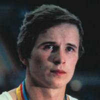 Portrait of gymnast Alexandr Dityatin, wearing his gold medal.