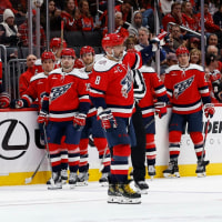 Oct 25, 2025; Washington, District of Columbia, USA; Washington Capitals left wing Alex Ovechkin (8) waves to fans while being honored for playing his 1,500th NHL game during a timeout against the Ottawa Senators during the first period at Capital One Arena. Mandatory Credit: Geoff Burke-Imagn Images