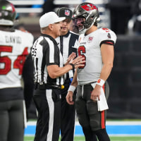 DETROIT, MICHIGAN - OCTOBER 20: Tampa Bay Buccaneers quarterback Baker Mayfield #6 and referee John Hussey #35 talk on the field during the second half of an NFL football game against the Detroit Lionsat Ford Field on October 20, 2025 in Detroit, Michigan. (Photo by Todd Rosenberg/Getty Images)