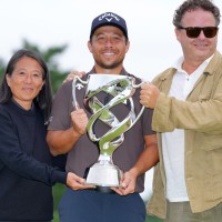 YOKOHAMA, JAPAN - OCTOBER 12: Xander Schauffele of the United States poses with his parents following the final round of the Baycurrent Classic Presented by LEXUS at Yokohama Country Club on October 12, 2025 in Yokohama, Kanagawa, Japan. (Photo by Yoshimasa Nakano/Getty Images)