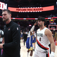 Oct 24, 2025; Portland, Oregon, USA; Portland Trail Blazers interim head coach Tiago Splitter walks towards the locker room with Trail Blazers’ forward Deni Avdija (8) after a 139-119 win over Golden State Warriors in the second half at Moda Center. Mandatory Credit: Jaime Valdez-Imagn Images