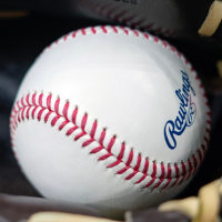 Apr 18, 2025; Milwaukee, Wisconsin, USA;  General view of a baseball in a glove during batting practice prior to the game between the Athletics and Milwaukee Brewers at American Family Field. Mandatory Credit: Jeff Hanisch-Imagn Images